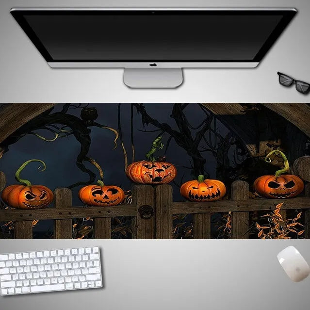 Large Halloween patterned gaming mouse pad on a desk showing non-slip rubber base and extra-long design.