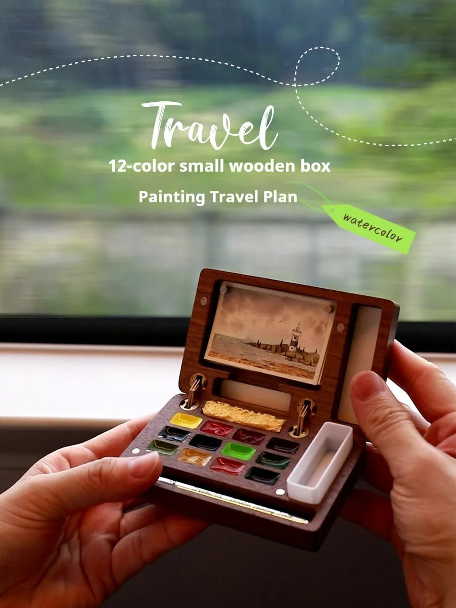 Mini wooden watercolour paint box with walnut finish, open to show pigment suit selection.