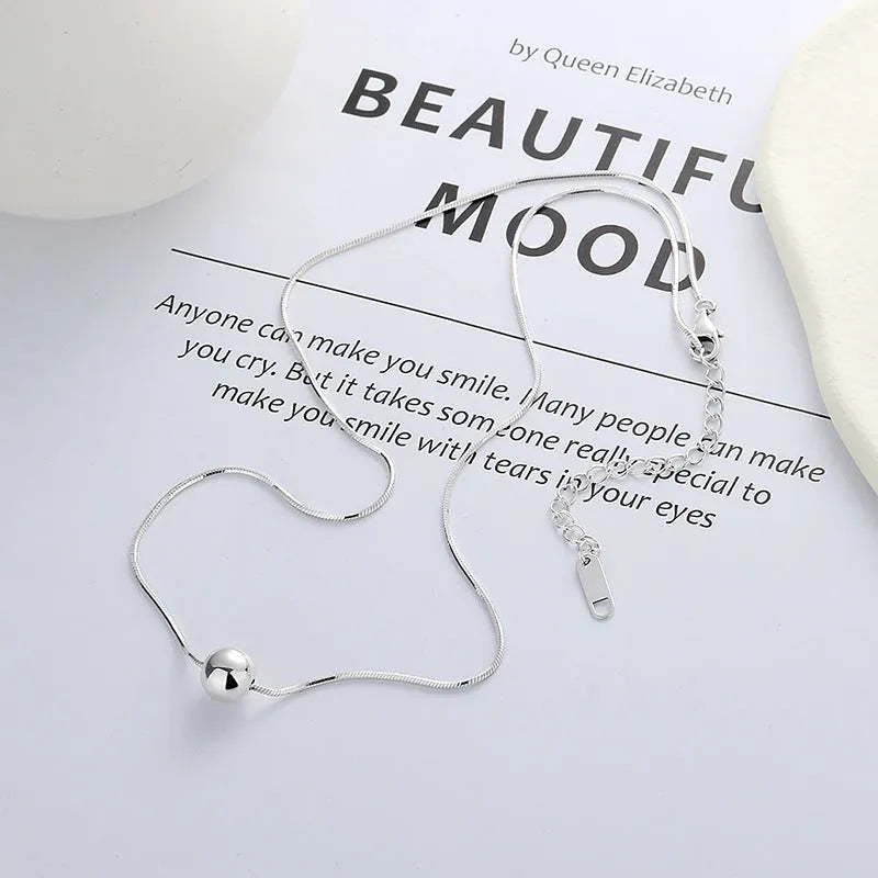 Silver necklace with small ball pendants on delicate chain for clavicle wear