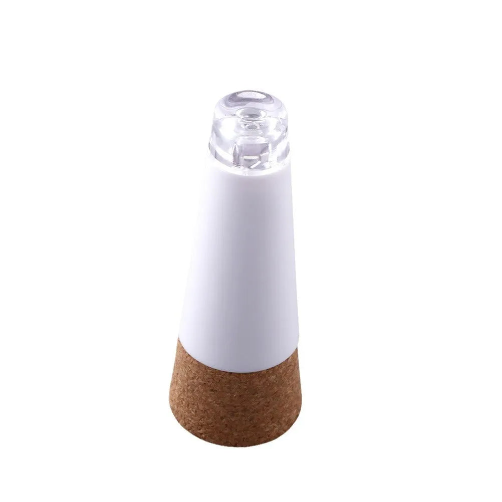 White plastic LED rechargeable bottle cap cork light with 15 beads, shown next to a wine bottle for scale.