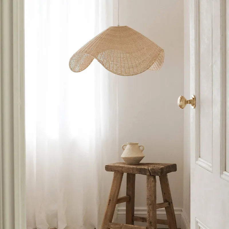 Handmade bamboo rattan chandelier with woven straw and willow lampshade in warm light