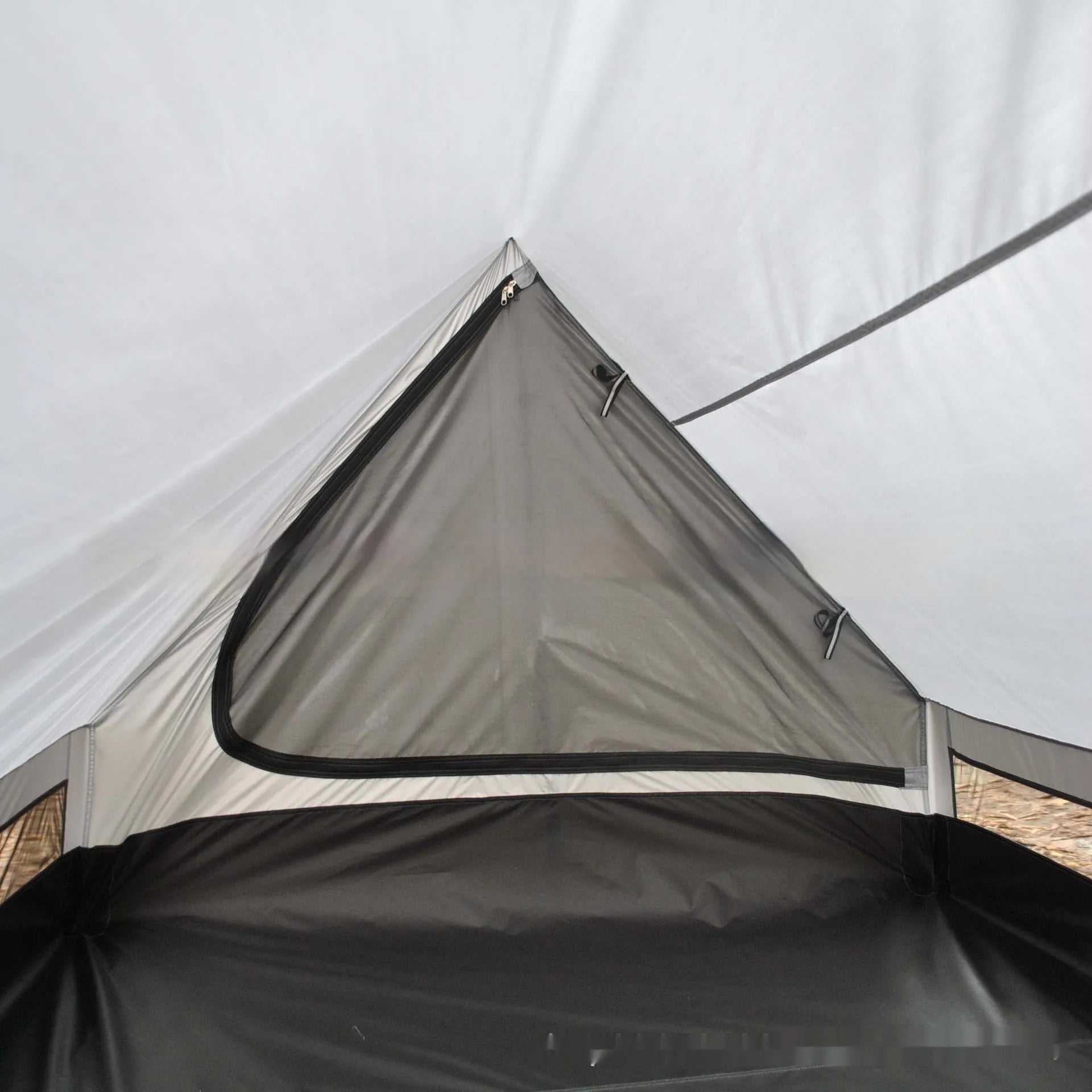 Brown and white pole-free A-line cabin tent for 2-3 people shown pitched with hiking poles.