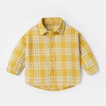 A boys' long sleeve cotton shirt with a lattice and cartoon pattern, shown in a light blue colour.