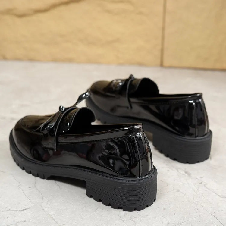 Women's brown and black flat loafers with a bow detail on the artificial PU upper.