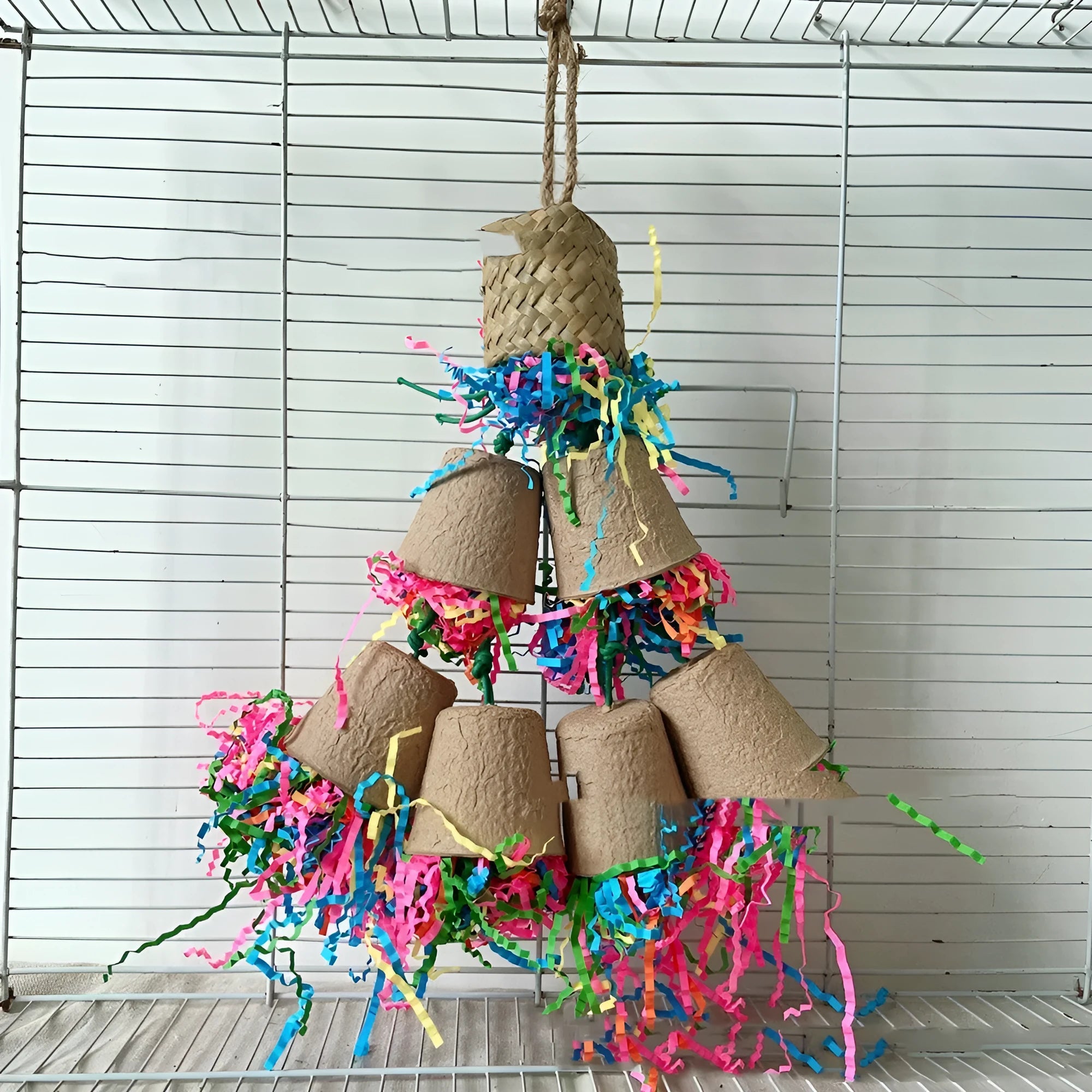 Parrot chewing toy made of woven palm with a paper cup, hanging at 38cm.
