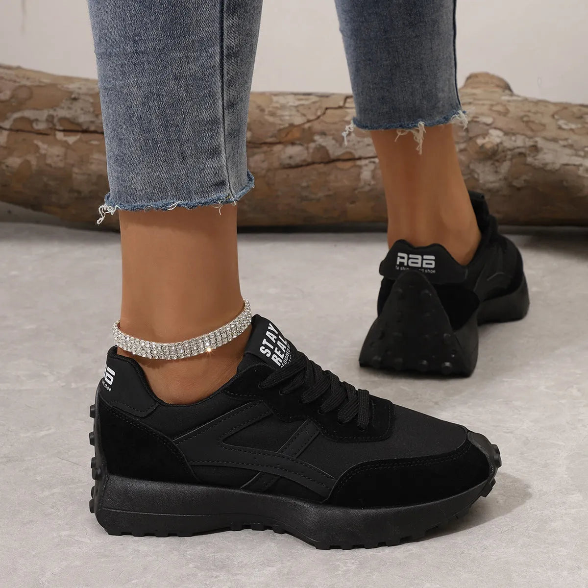 Black mesh sports flat shoes for women with synthetic leather upper and rubber sole, side view