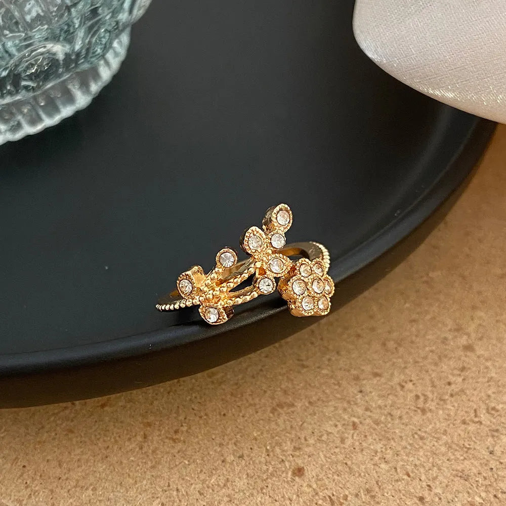 Copper open ring with flower and leaf design in gold or white diamond-treated finish