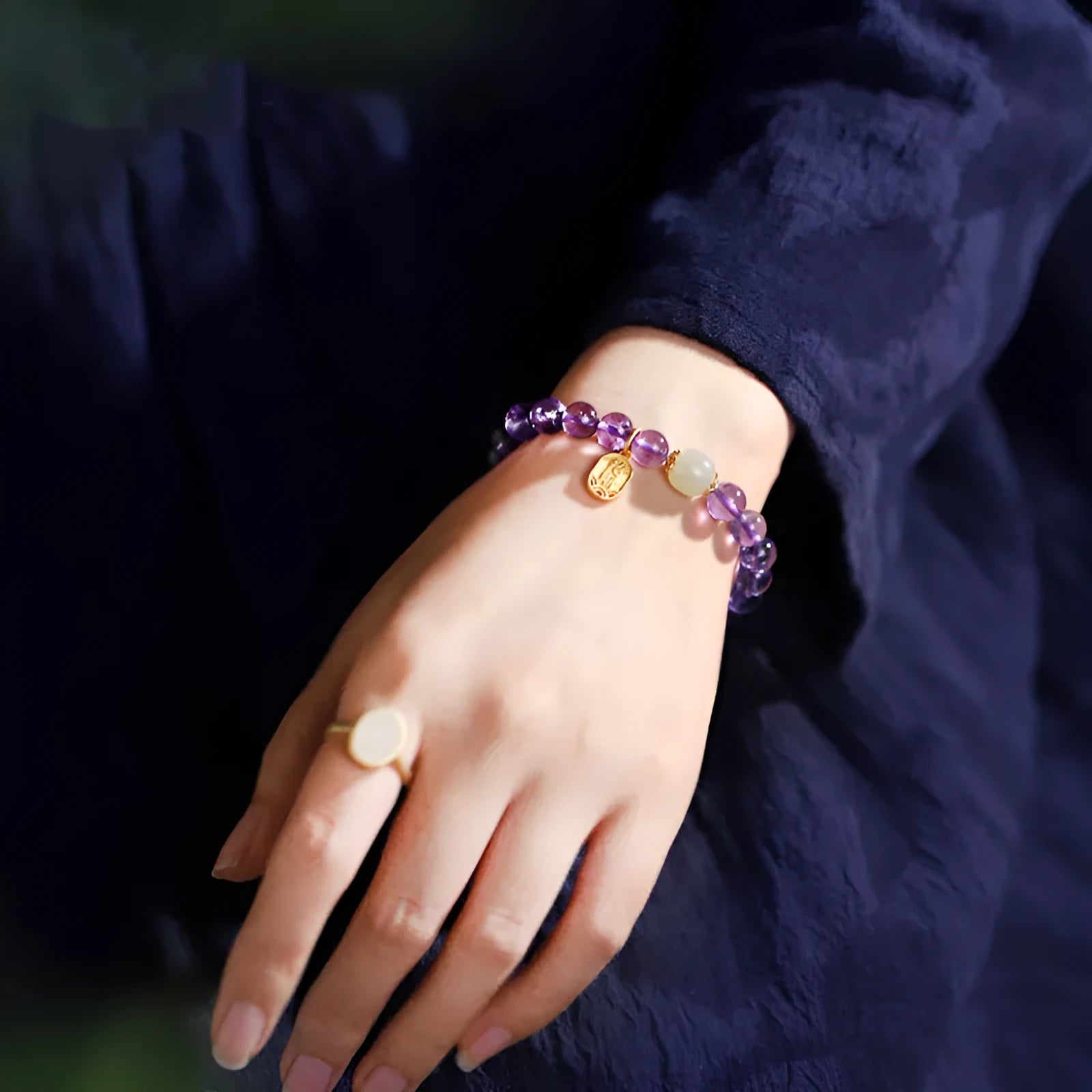 Amethyst colour crystal bead bracelet with 8mm round beads in a geometric national style design.