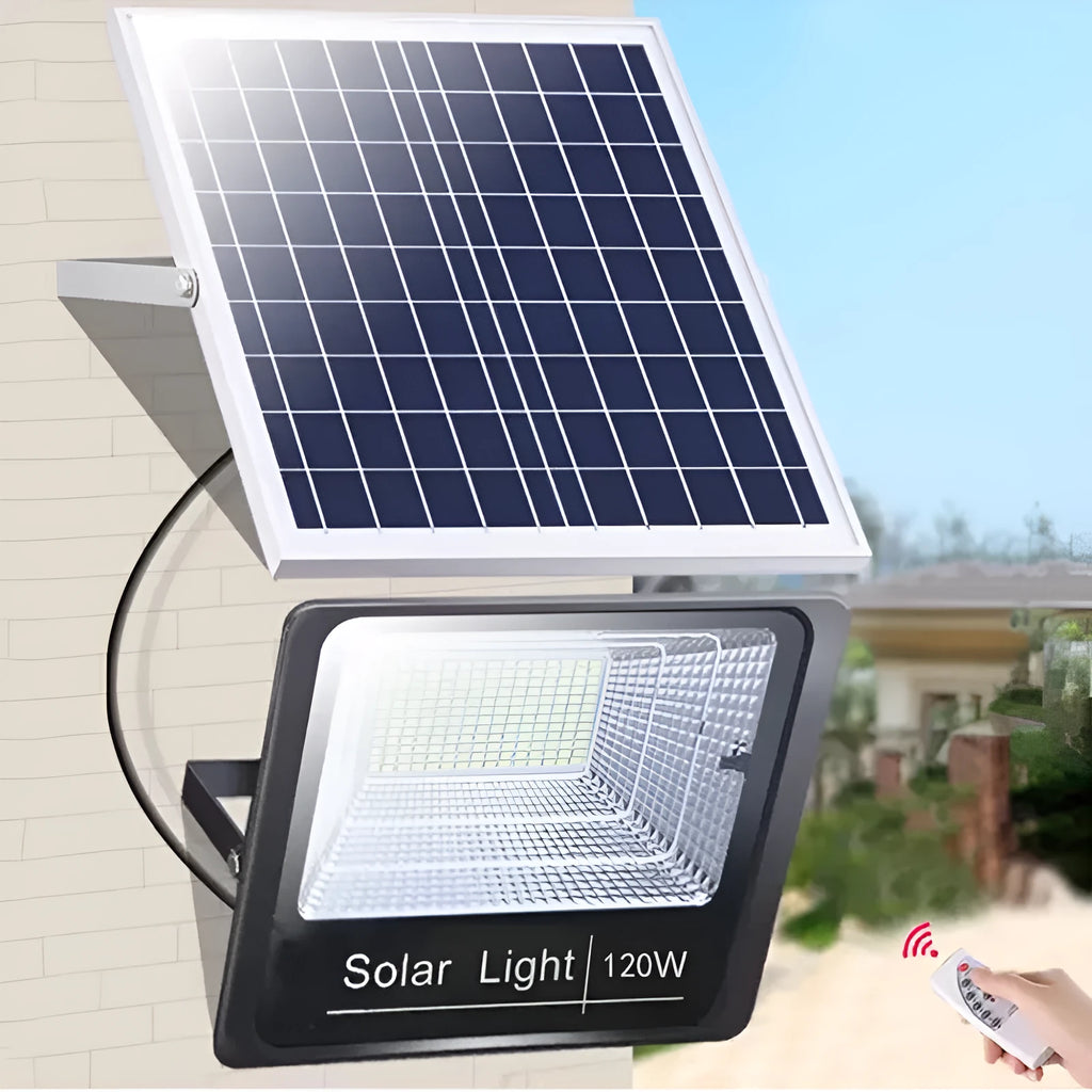 Black Cornucopia solar-powered LED flood light mounted on a garden wall with remote control.