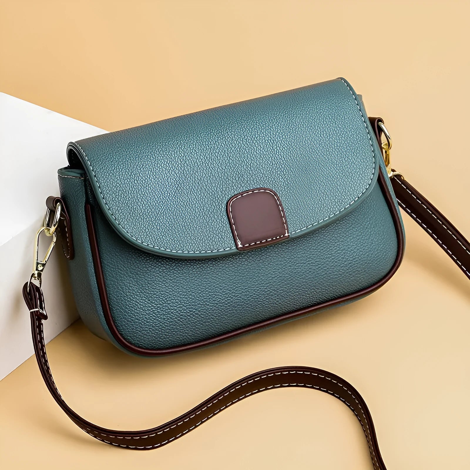 Small square PU crossbody bag with flap closure and adjustable strap in khaki, black, blue, yellow