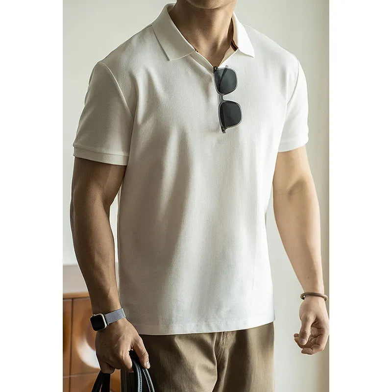 Blue short-sleeved polo shirt on a hanger, showing regular fit and cotton-polyester fabric blend.