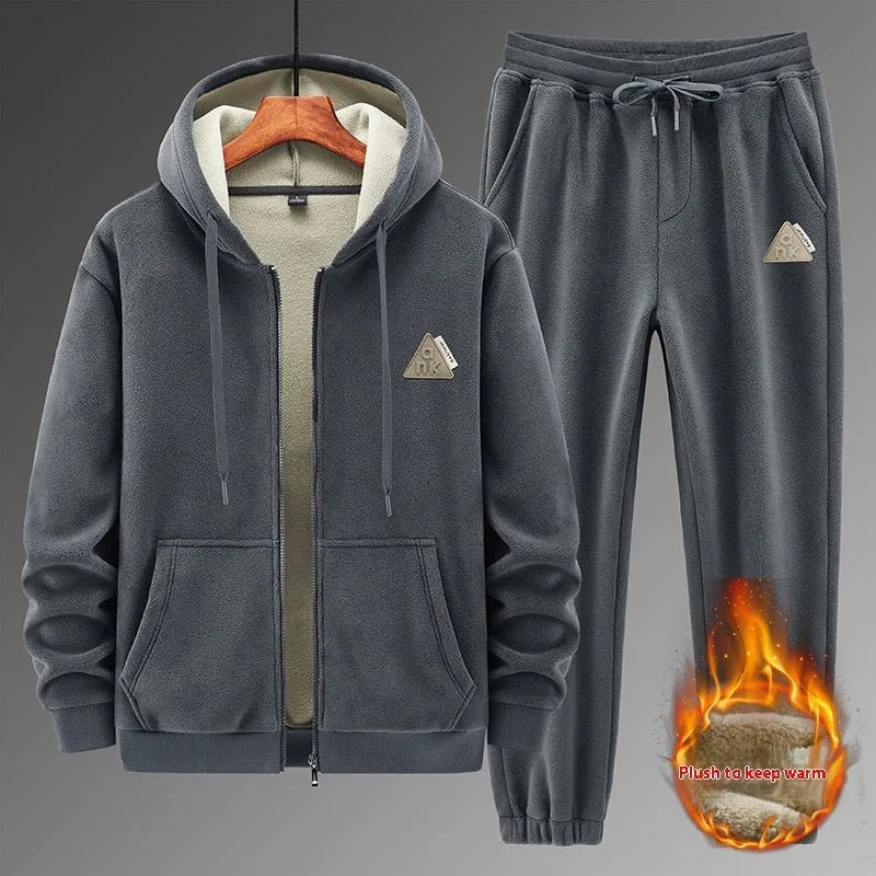 Man wearing a grey hooded sweatshirt and matching tracksuit pants from a casual two-piece set.