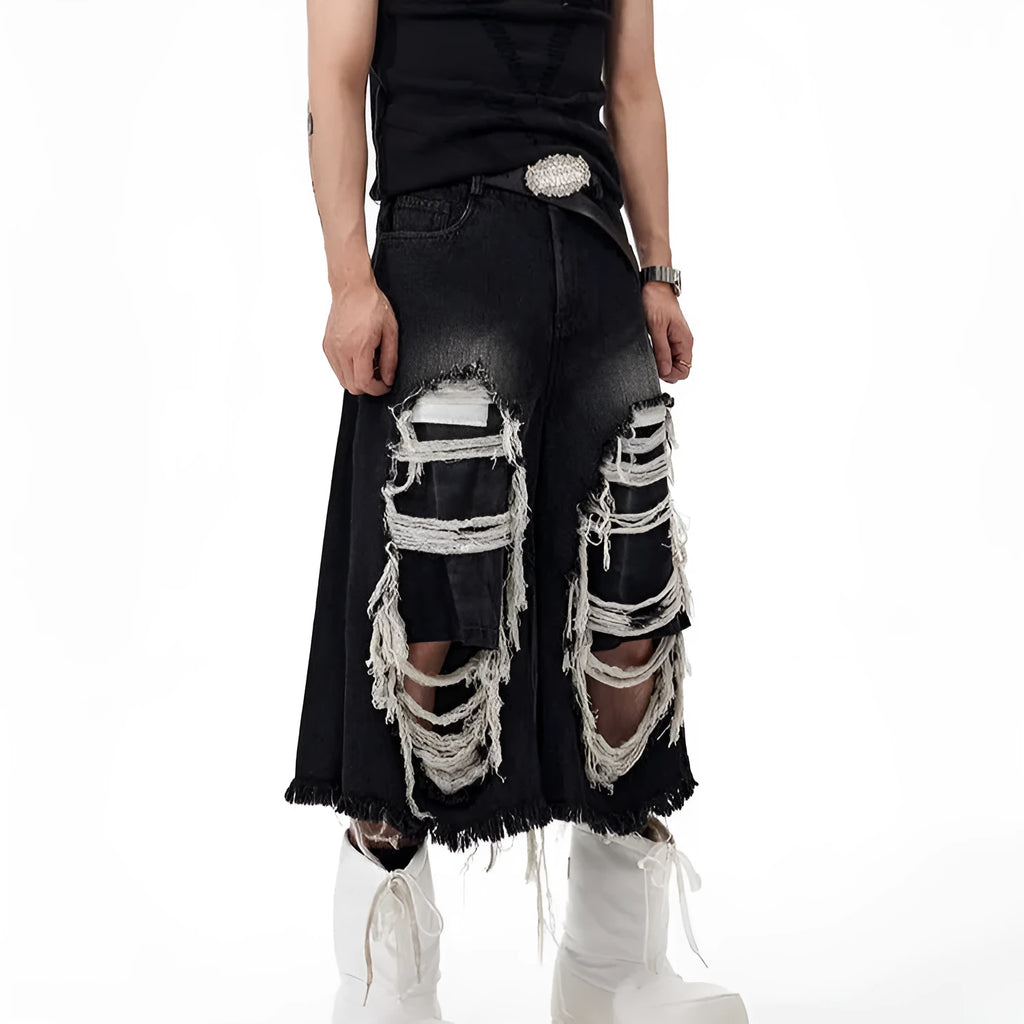 Black wide-leg cropped jeans with a ripped patch detail on the leg, shown on a model.