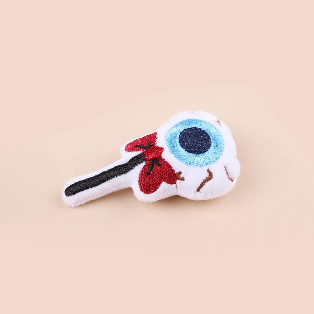 Small cat teaser wand toy with plush candy and skull attachments on string