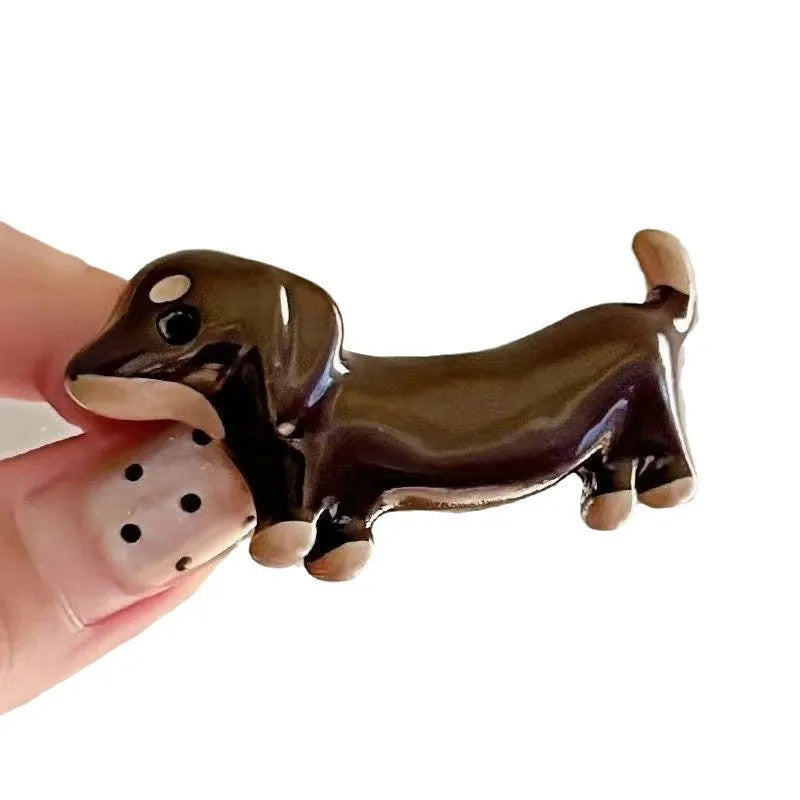 Dachshund dog shaped hair barrettes with electroplated finish, shown as a single clip or a pair.