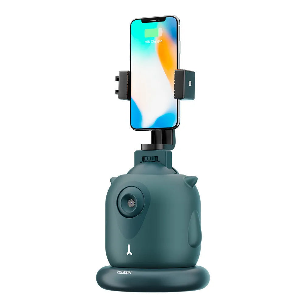 Dark green intelligent AI face tracking gimbal with 360-degree rotation on a table.