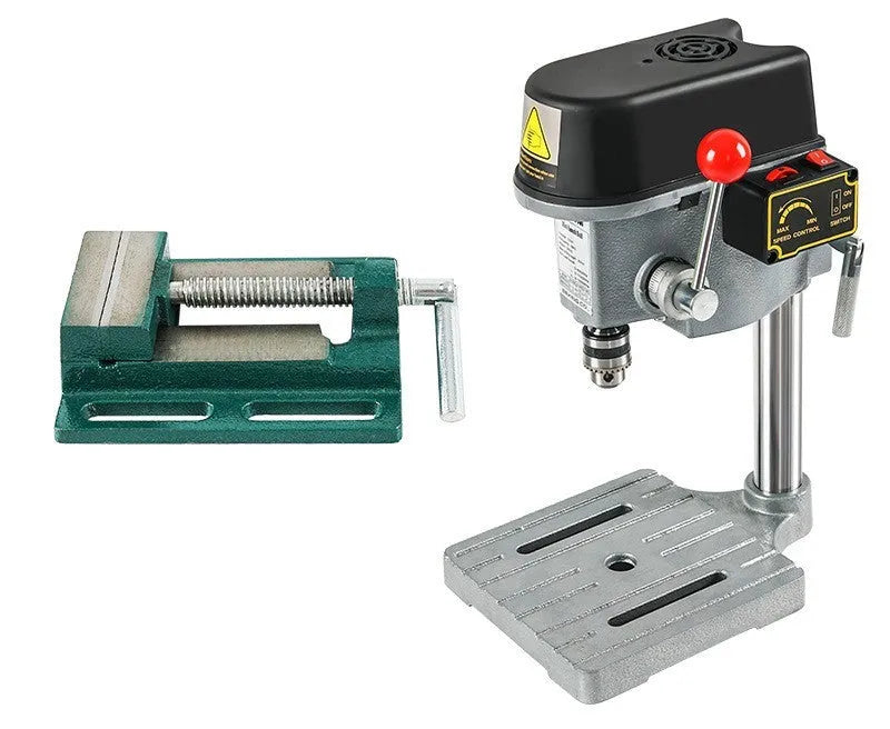 Mini bench drill and milling machine with heavy duty bench pliers on a workbench.