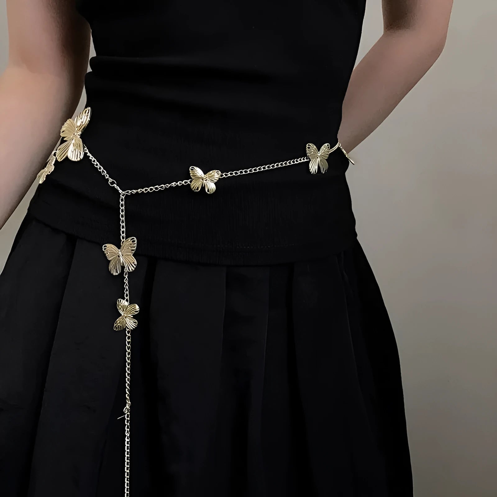 Gold or silver alloy waist chain for women featuring a butterfly design, showing its 104cm length.