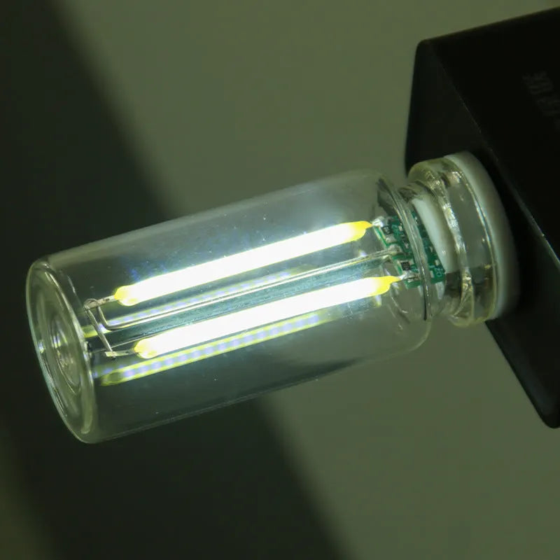 Small transparent glass USB touch night lamp with warm white light on a desk