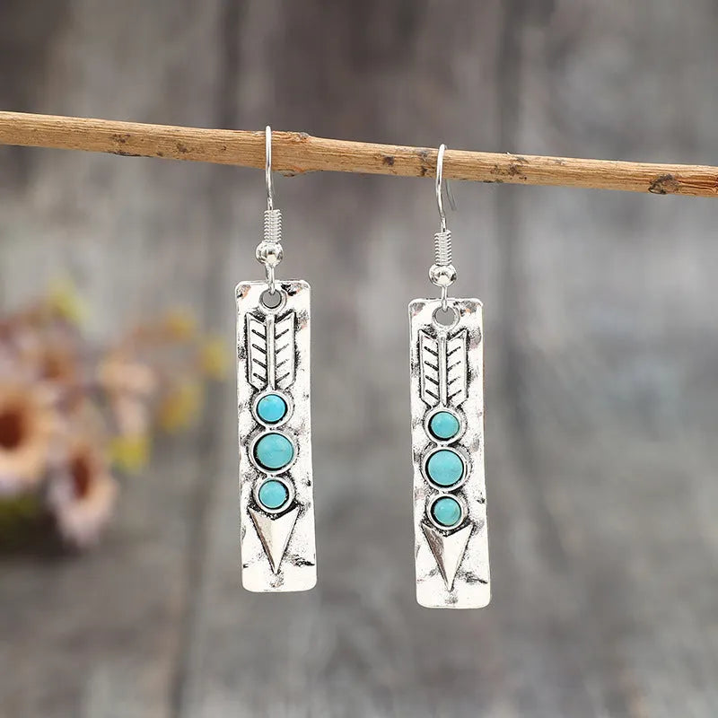 Women's silver geometric long strip earrings with turquoise detail and retro styling