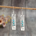Women's silver geometric long strip earrings with turquoise detail and retro styling