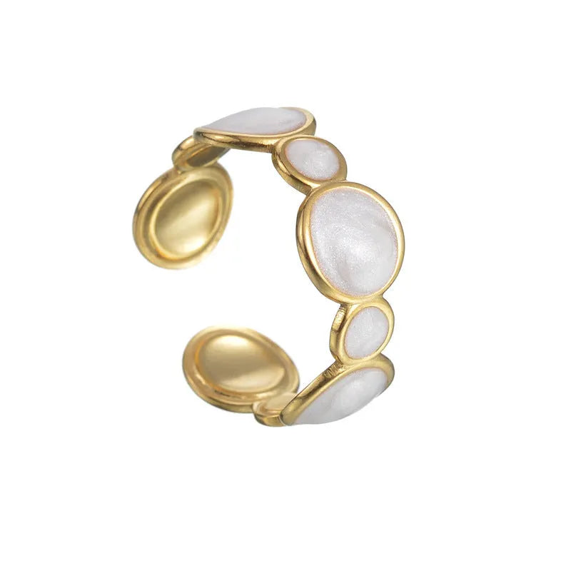 A stainless steel ring with a geometric design and adjustable opening on a plain background