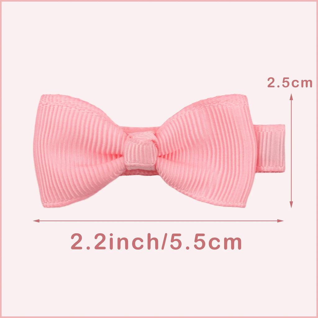 Assortment of pastel-coloured baby hair clips including barrettes and bows on a white background.