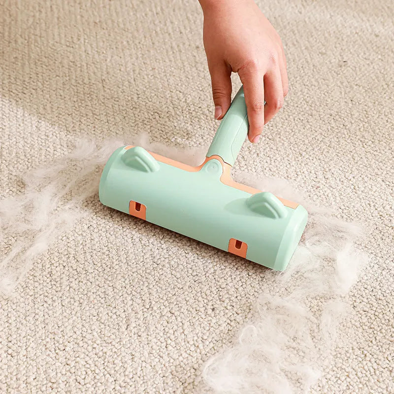 Mint green and twilight grey cat hair removal brush with two head style options on a white background.