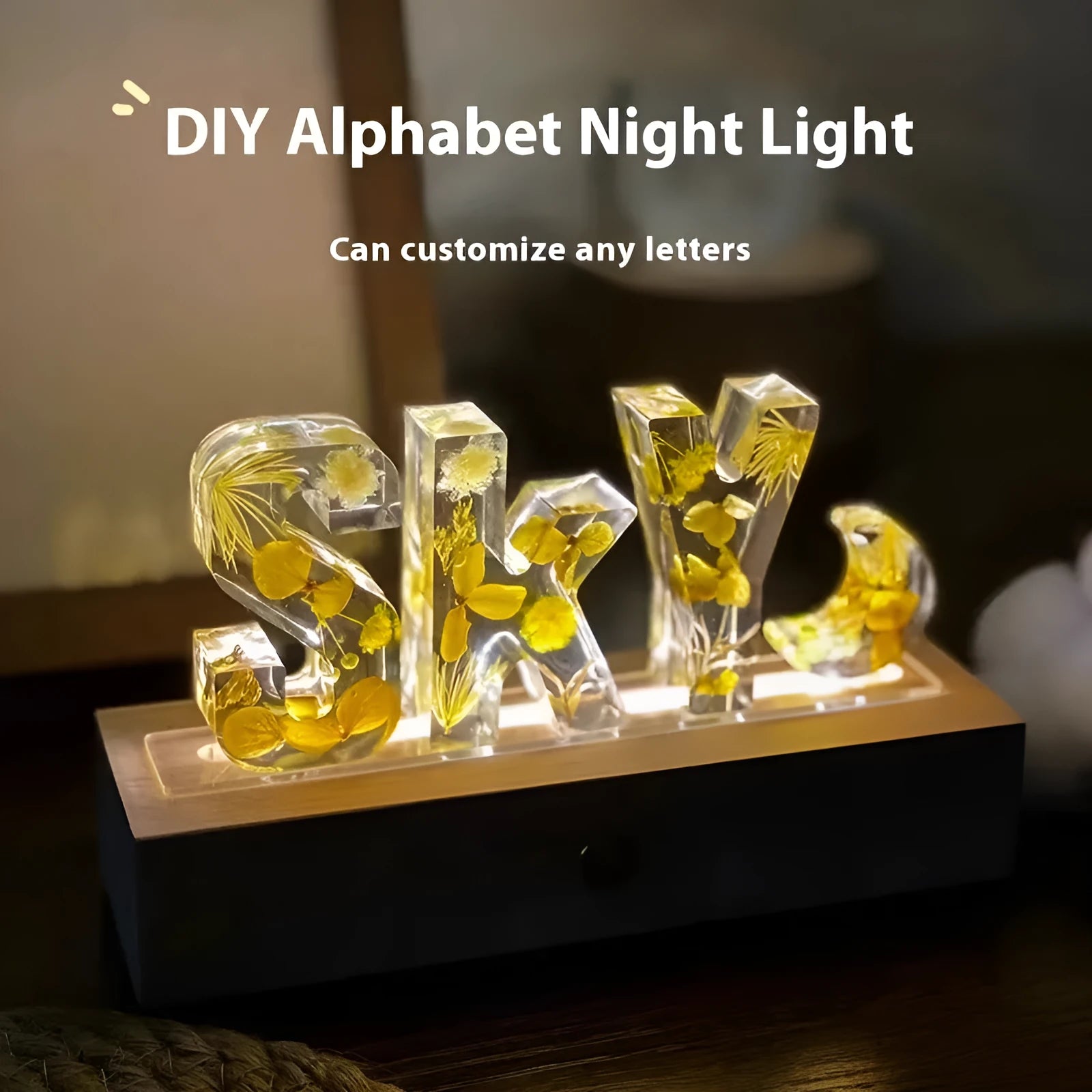 Letter small night lamp with dried flowers, blue colour, warm light, on a table