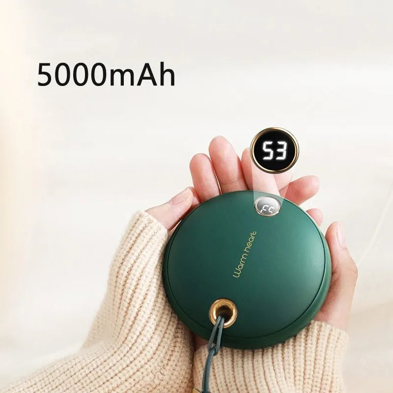 Green square hand warmer power bank with digital display showing charge level, next to a charging cable.
