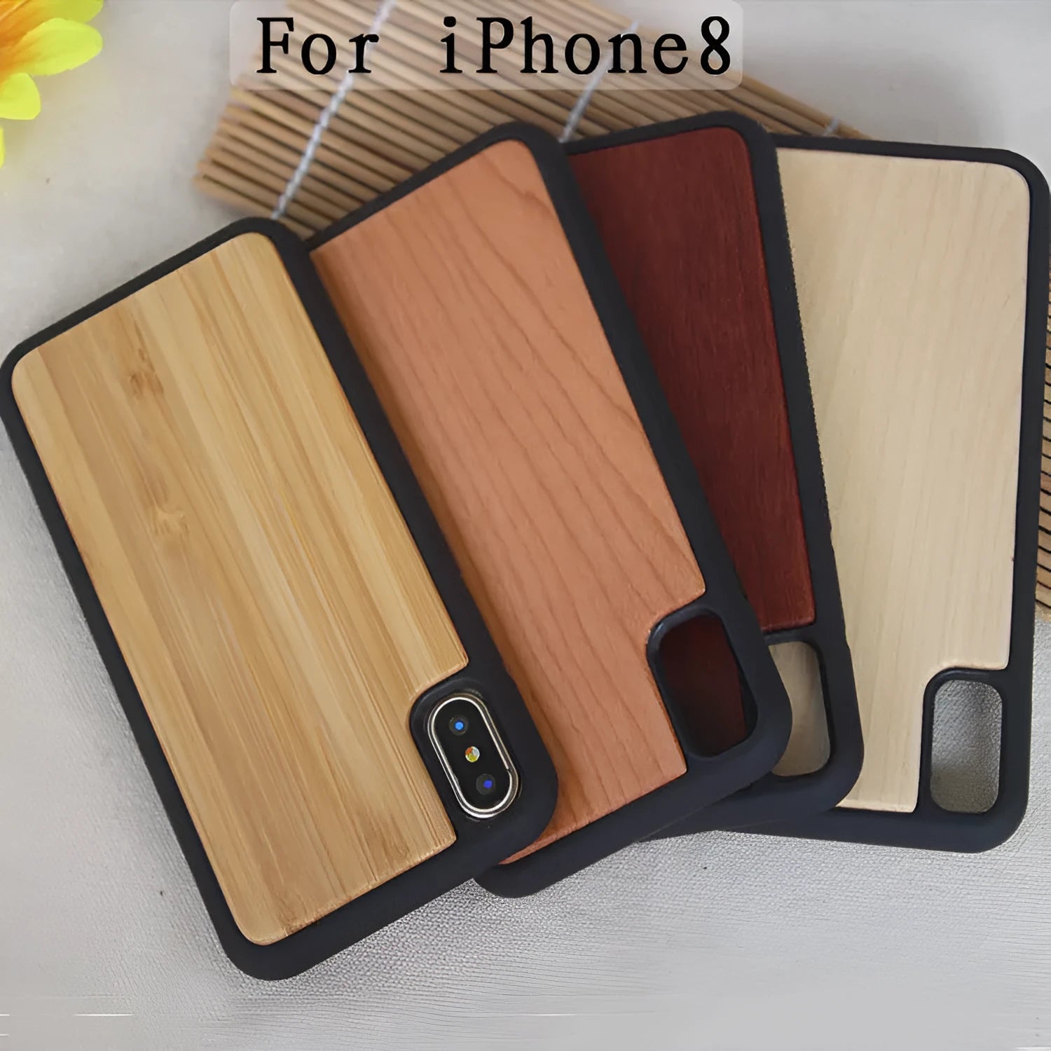 Wooden iPhone case with carbonised bamboo back and black TPU bumper frame on a wooden table.