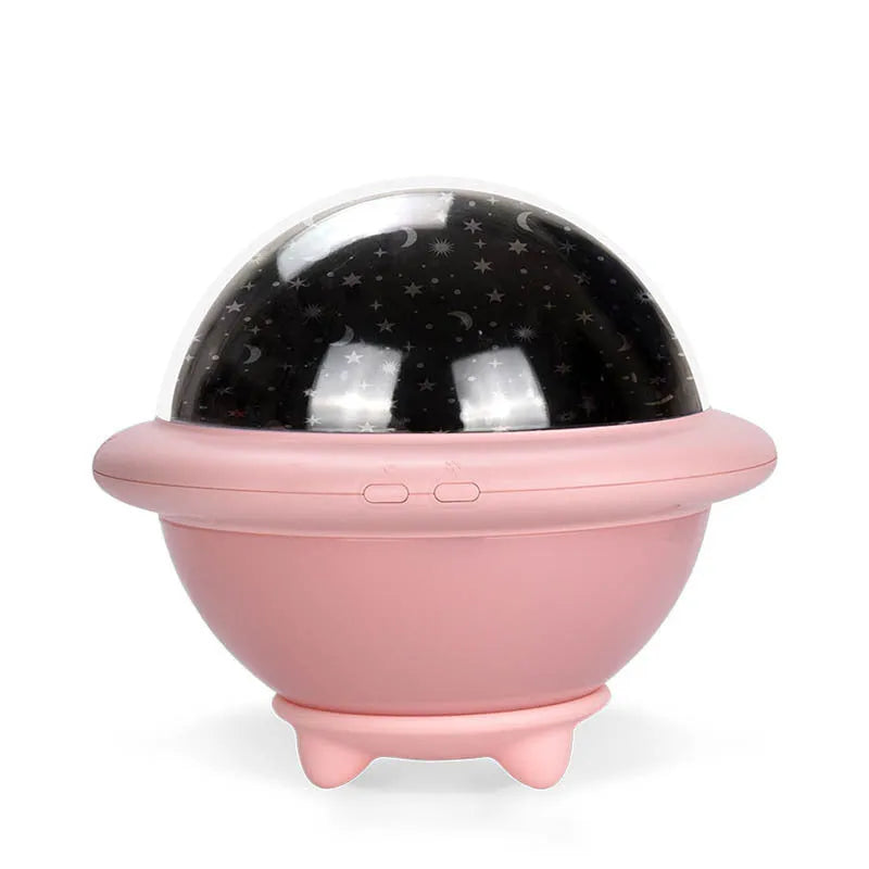 Pink UFO-shaped plastic LED night light projecting starry sky pattern on wall