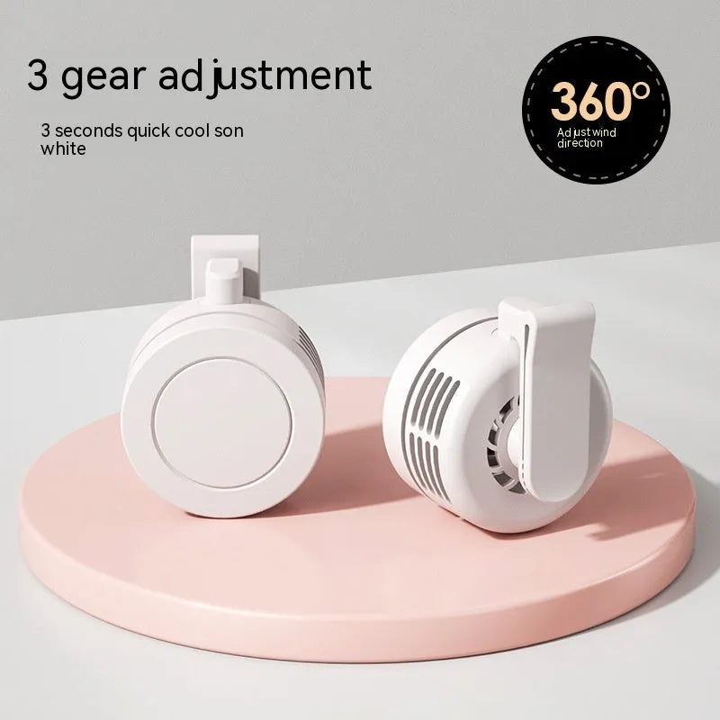 Green wrist hanging personal fan with light and USB charging port on a compact ABS and silicone body.