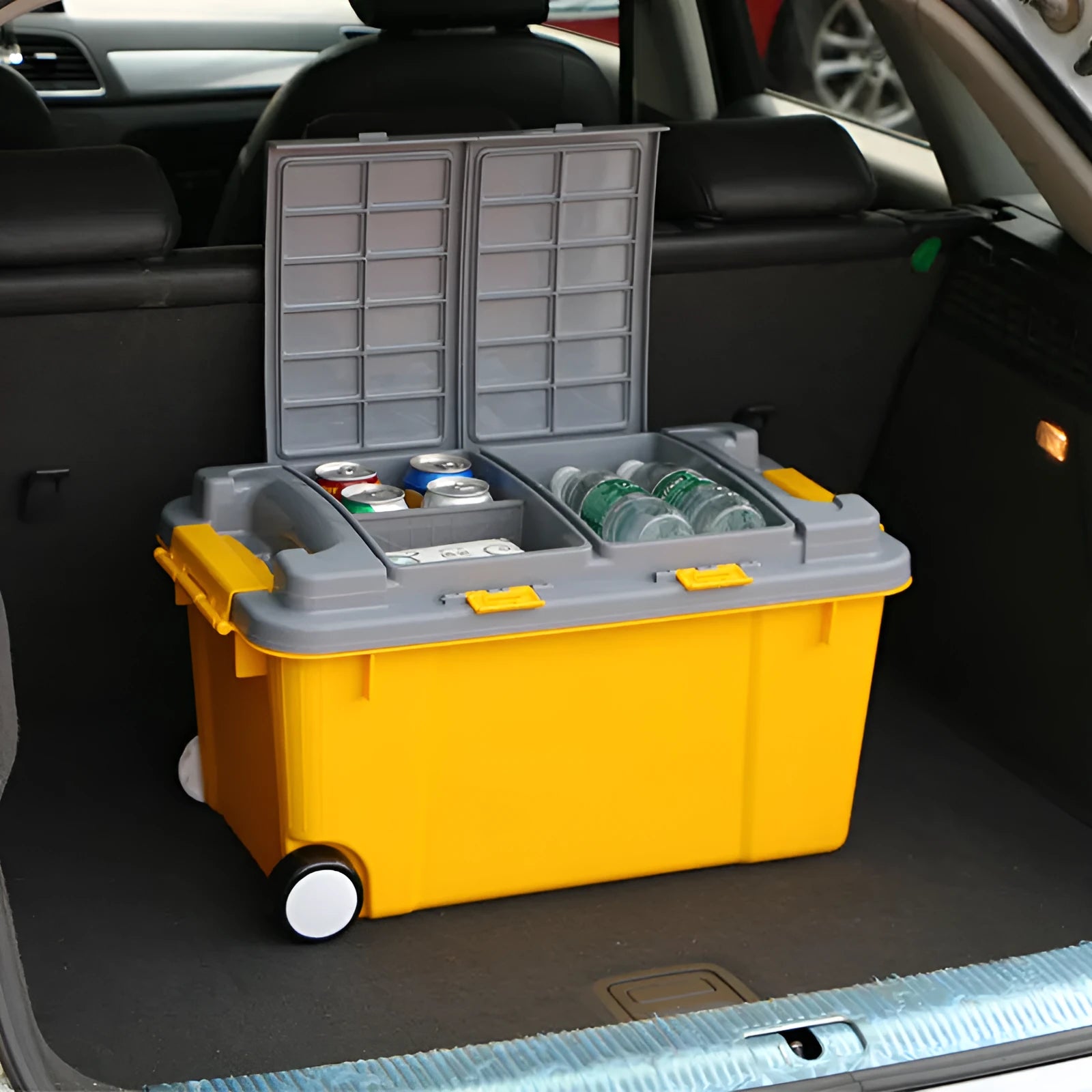 Large orange plastic storage box with wheels and an extended pull handle on a grey floor.