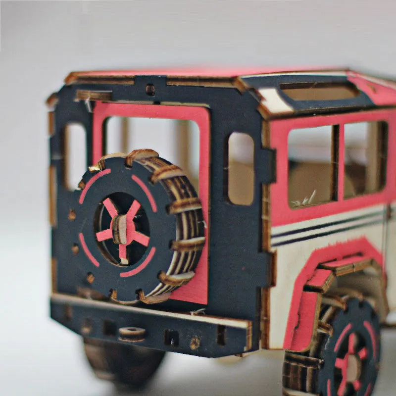 3D wooden puzzle kit showing a Ferrari style model with interlocking pieces on a table