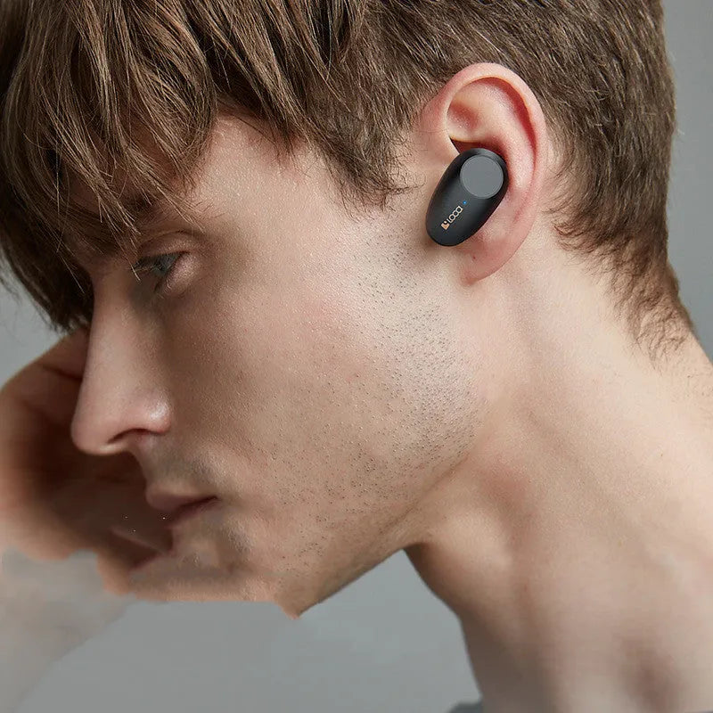 Black wireless Bluetooth headset with charging stand showing bilateral earbuds and Type-C charging port