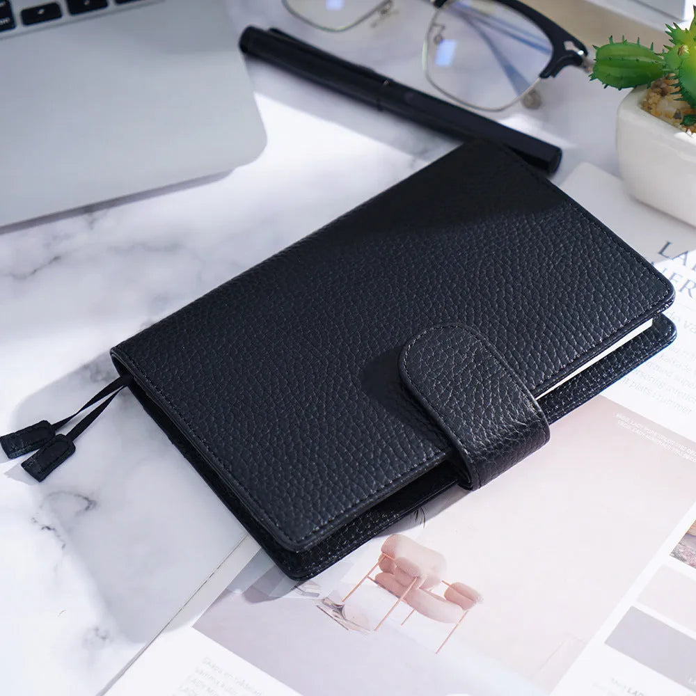 A6 loose-leaf diary with cowhide leather cover showing lychee pattern texture