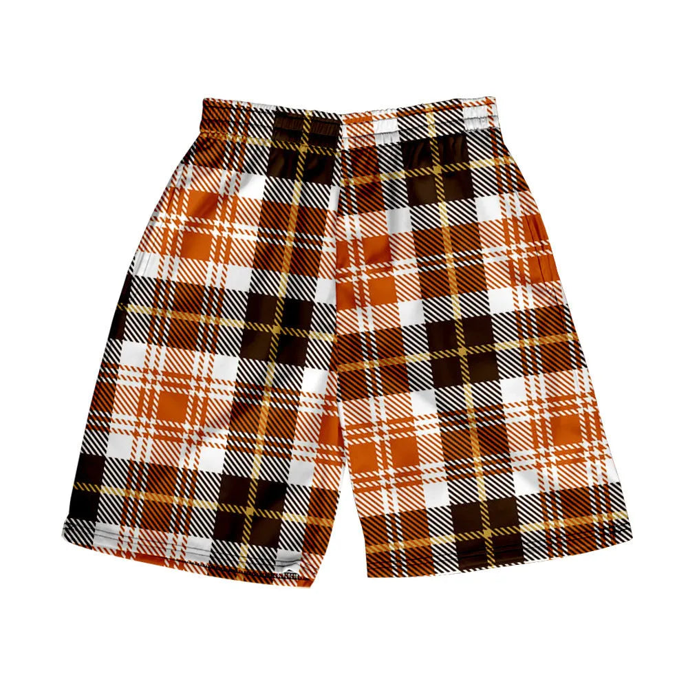 Man wearing straight-leg plaid shorts with an elastic waistband on a beach, showing one of twenty available colour variations.