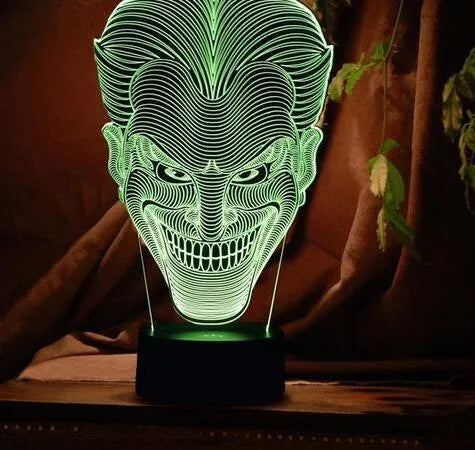 USB-powered 3D acrylic LED lamp displaying multiple colours on a desk with remote control.
