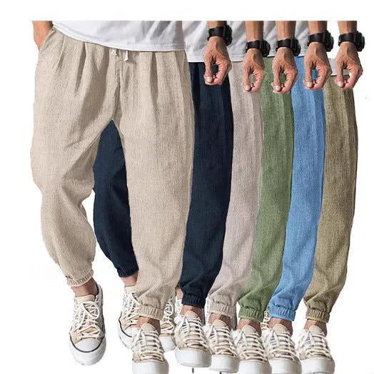 Men's loose-fit light green cotton casual trousers with a banded ankle cuff on a plain background.