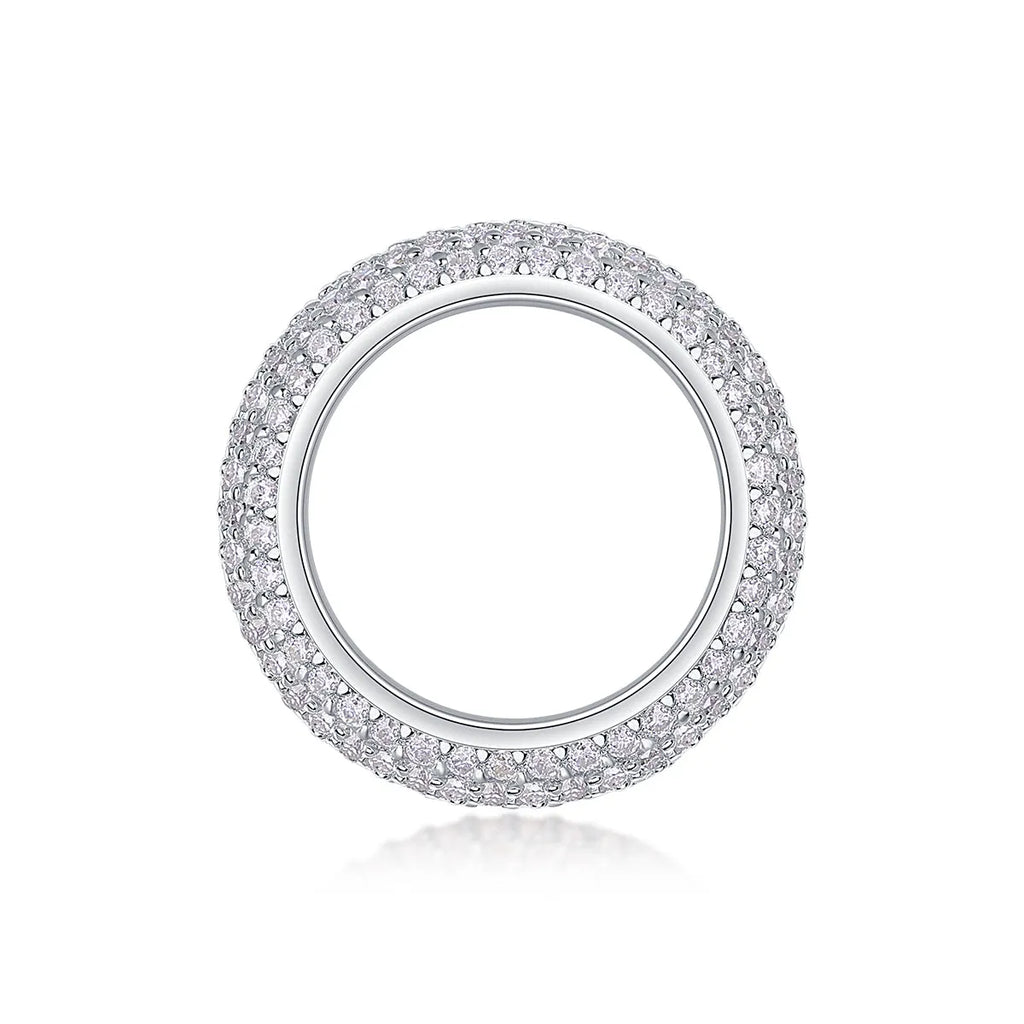 Moissanite wedding ring with S925 silver platinum plated band on flat surface showing stone and certificate