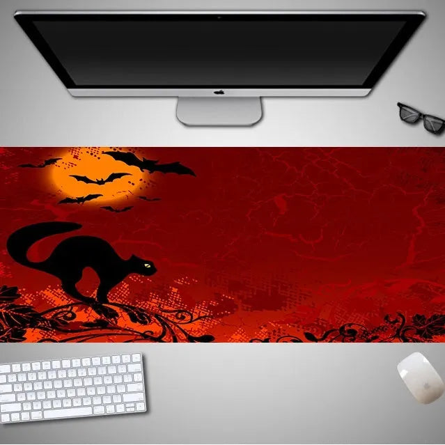 Large Halloween patterned gaming mouse pad on a desk showing non-slip rubber base and extra-long design.