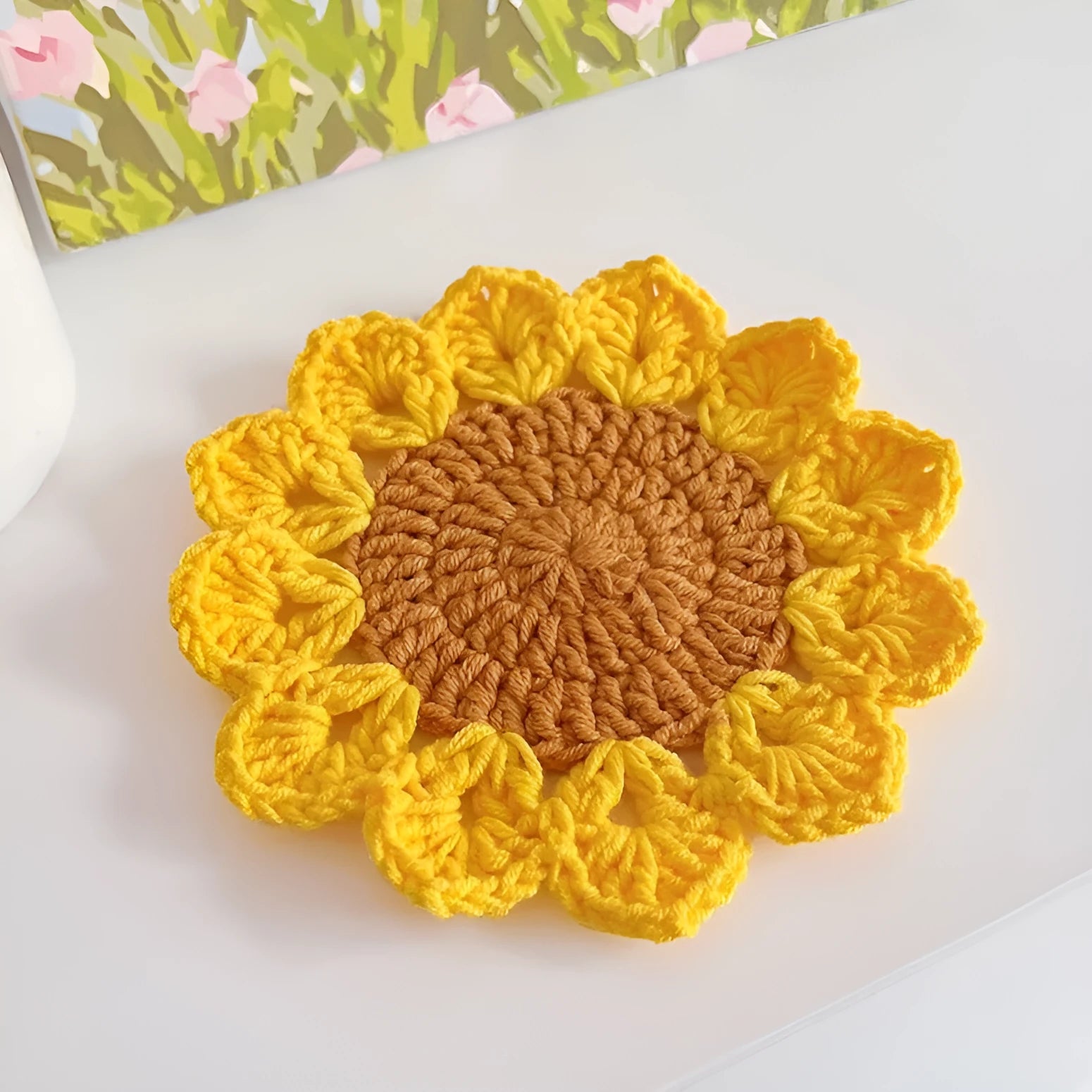 Hand-woven wool coaster set for drinkware on a tabletop.