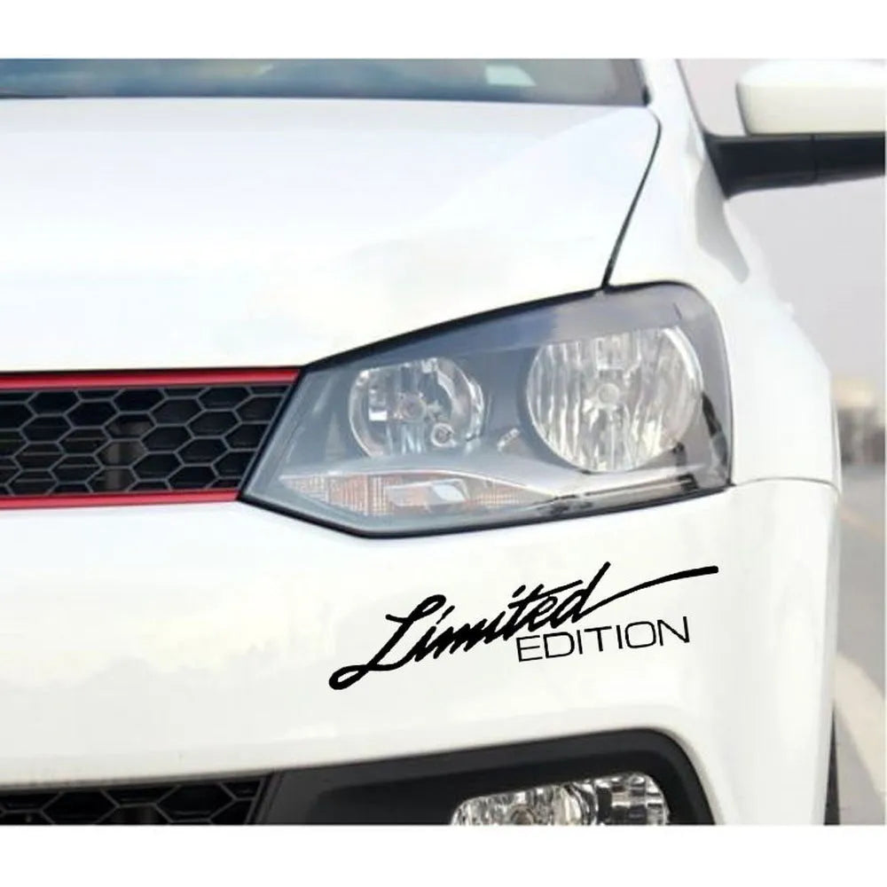 A reflective plastic bumper sticker measuring 16cm by 3.8cm, shown in black, white, and multicolour options.