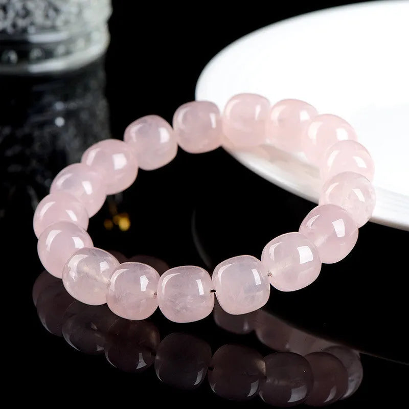Pink bamboo crystal barrel bead bracelet with 11-12mm beads on a wrist.