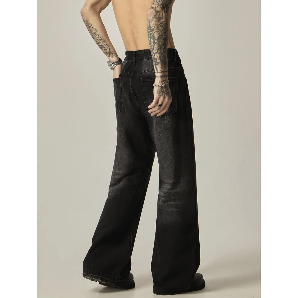 Black loose straight-leg jeans with a retro light wash and zip fly closure laid flat.