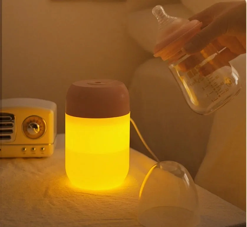 Small white cylindrical USB-powered humidifier with charging cable.