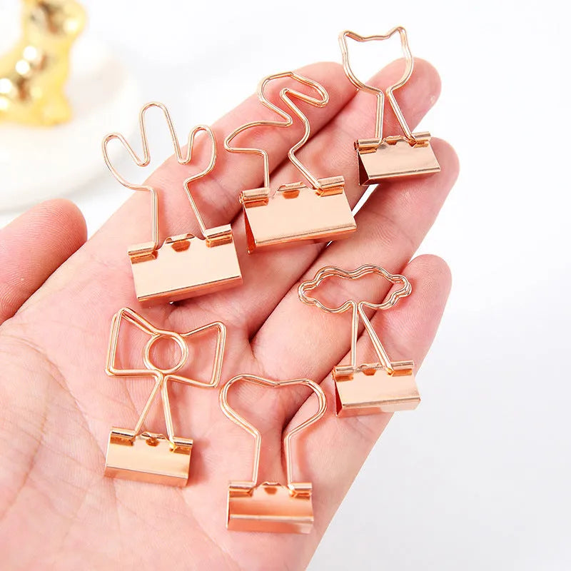 Gold long tail metal clip with a decorative flamingo, love, clouds, cat, cactus, or bow design top.