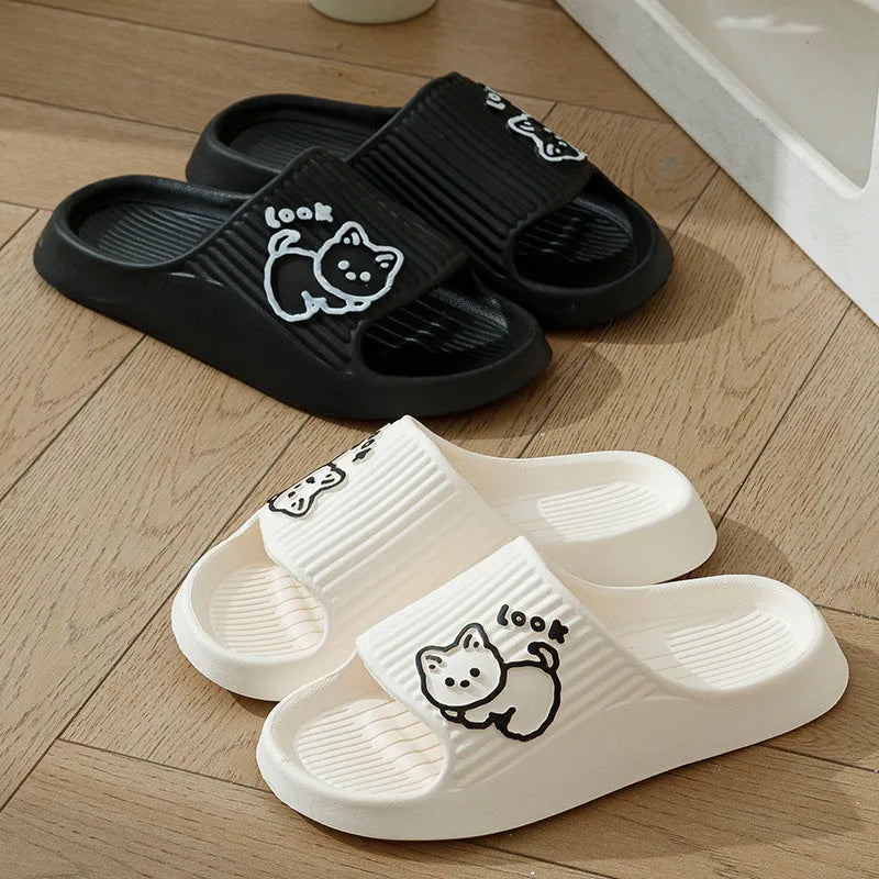 Women's pink EVA cat slippers with thick platform sole on a wooden floor.