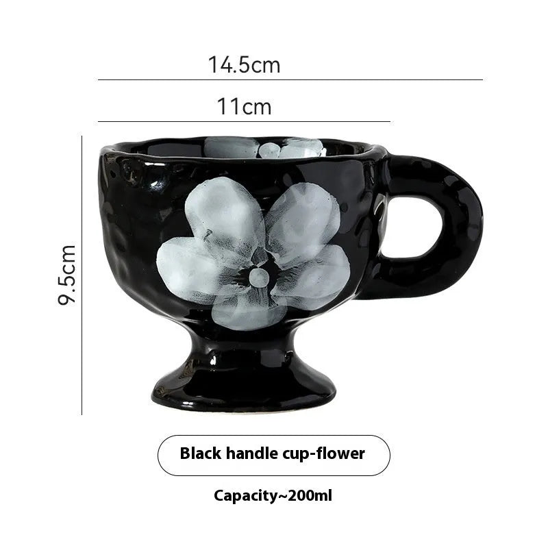 Handmade irregular solid colour ceramic mug on a table, showing its unique shape.